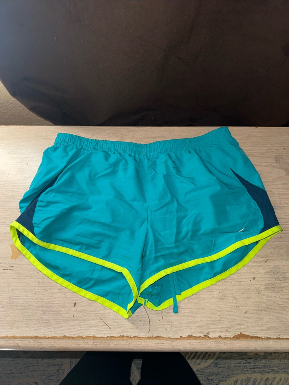 Nike women’s blue & green running shorts with neon yellow trim, size M